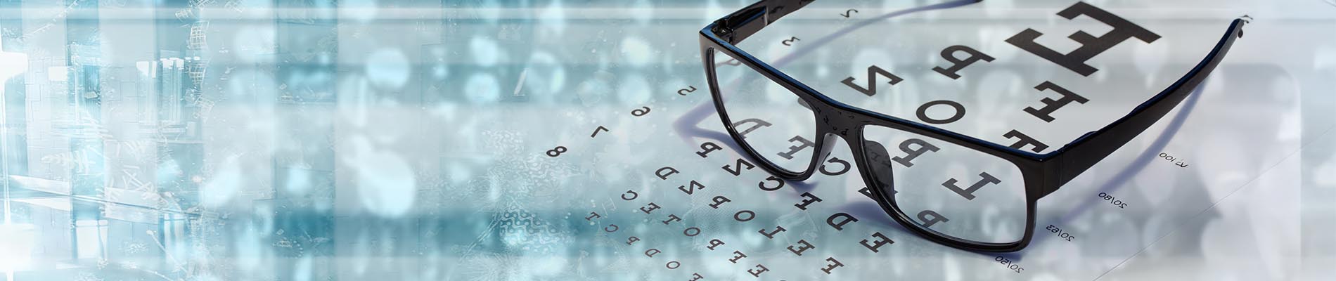 The image shows a group of people, possibly professionals given their attire and the setting that appears to be an office or professional environment. They are gathered around a table with a laptop on it, engaged in what seems to be a discussion or meeting.